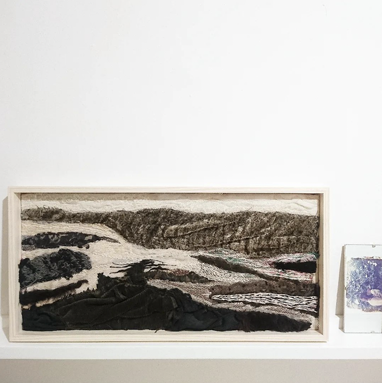 monochrome textile of an abstract landscape framed in slimline ash