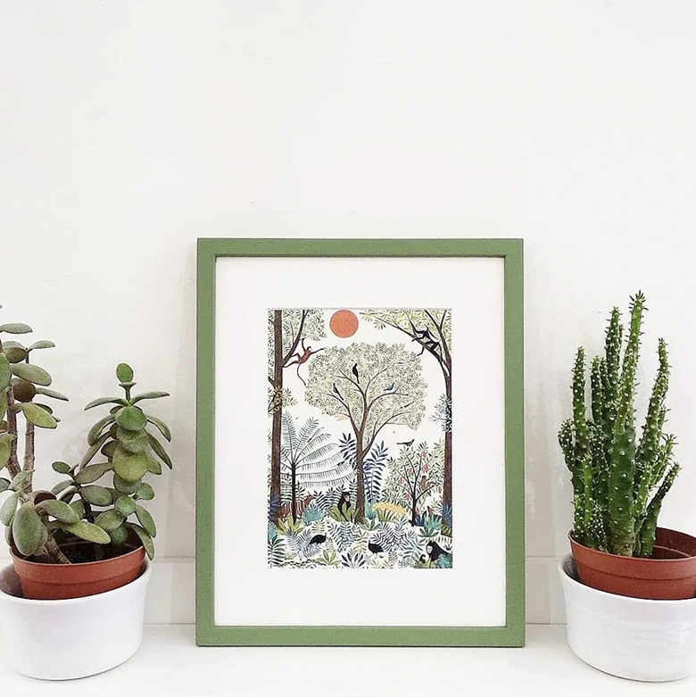 print of forest scene with birds and monkeys mounted and framed in slim square frame hand-painted mid green